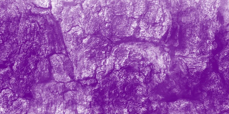 Purple-tinted rough rock surface texture