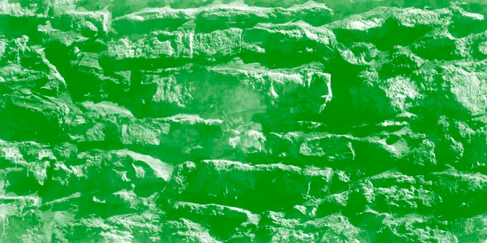 Green-tinted rough stone wall texture